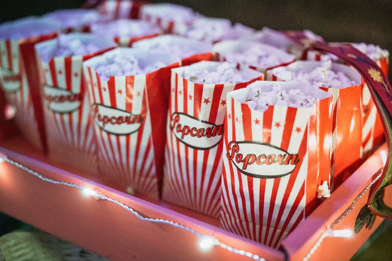 A dozen red popcorn bags in a red box 