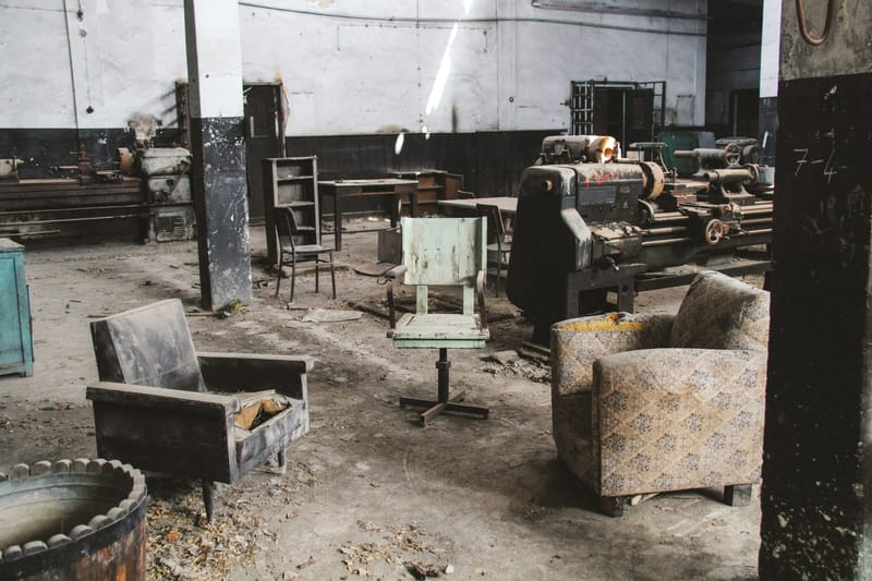 Dirty old garage with old beat up furniture 