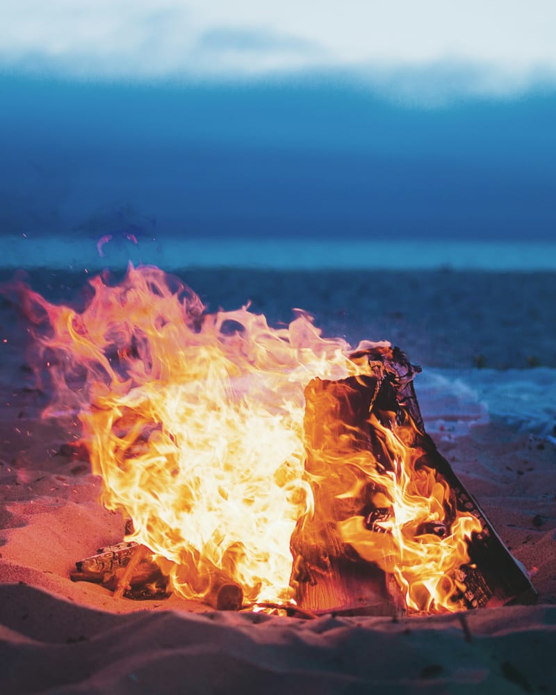 Beach bonfire with a focus on wood burning